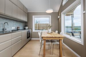 a kitchen with a table and chairs and a window at Golden Circle Private Escape with Guesthouse 
