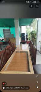 a large wooden table in a room with chairs at Turtuk in Turtuk