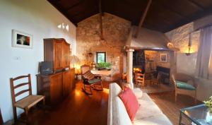 a living room with a couch and a table at Casa Gallega Tradicional La Mar in A Guarda