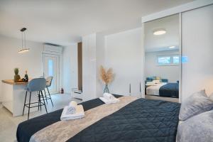 a bedroom with a large bed with towels on it at Mićos Beach Studio with Pool in Slatine +16 photos