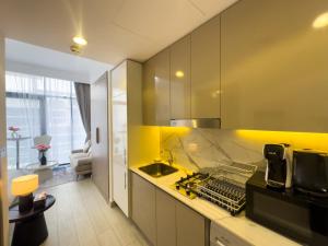 a kitchen with yellow walls and a yellow counter top at Luxe Studio Vibes Stylish & All New Pet Free in Dubai