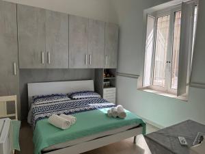 a bedroom with a bed with towels on it at B&B Il sogno in Cagliari +5 photos