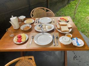a wooden table with plates of food on it at Ritter Kreuz Cabana Resort in Tangalle