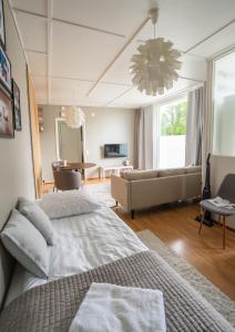 a bedroom with a large bed and a living room at Ranua Keskustie Polar Apartment in Ranua