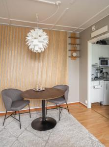 a dining room with a table and chairs and a chandelier at Ranua Keskustie Polar Apartment in Ranua