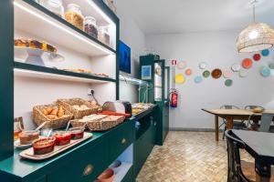 a kitchen with a counter with food on it at Casa do Bairro by Shiadu in Lisbon +45 photos