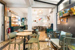 a restaurant with tables and chairs in a room at Casa do Bairro by Shiadu in Lisbon