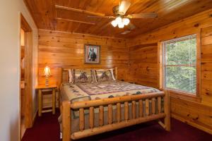 a bedroom with a bed in a log cabin at Moose Lodge by American Patriot Getaways in Walnut Grove