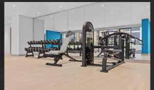 a gym with several treadmills and cardio equipment at Luxe Studio Vibes Stylish & All New Pet Free in Dubai