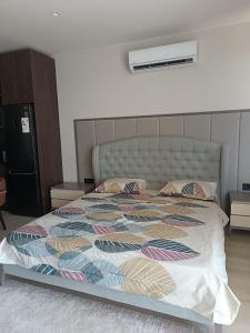 a bedroom with a large bed with a comforter at Seabreeze Park Residence 2 in Nardaran +5 photos
