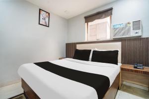 a bedroom with a large bed and a window at Hotel O by OYO Exotica Palace in New Delhi +20 photos