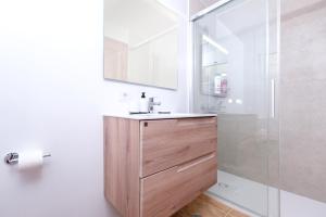 a bathroom with a sink and a shower at Apartamento El Charcon A - 10 meters to the Beach By Lanzarote Vacation Homes in Arrieta +24 photos