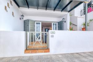 an open door to a house with white walls at Apartamento El Charcon A - 10 meters to the Beach By Lanzarote Vacation Homes in Arrieta