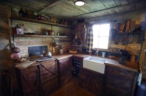 a kitchen with a sink and a stove and a window at The Karal cabin in Canterbury