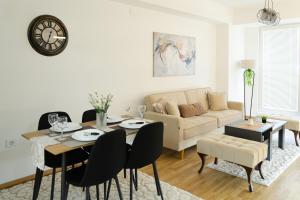 a living room with a table and a couch at Comfort Apartment Skopje in Skopje