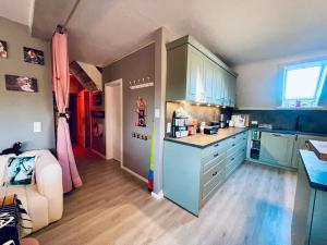 a kitchen with blue cabinets and a counter top at Exklusives Heidehaus in Garlstorf mit Musikzimmer in Garlstorf