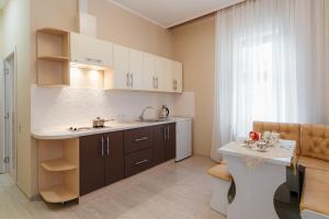 a small kitchen with a sink and a table at Asiya in Odesa
