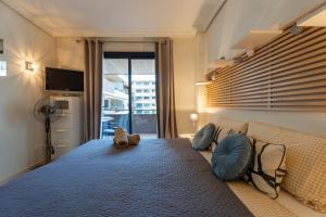 a bedroom with a large bed with blue pillows at El Teide in Puerto de Santiago +42 photos