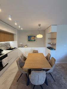 eine Küche mit einem Holztisch und einigen Stühlen in der Unterkunft RIVERSIDE Kozloduy in Kozloduy + 6 Fotos