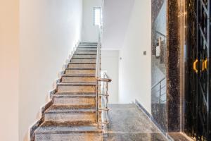 a set of stairs in a building with a metal railing at Hotel O Holiday Luxury in Hyderabad