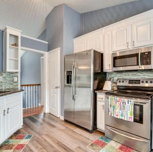 a kitchen with stainless steel appliances and white cabinets at Stunning Private Villa in Monroe with Pool in Monroe