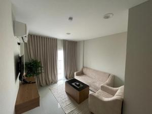 a living room with a couch and a table at AL Ghaith Hotel Apartment الغيث للأجنحة الفندقية in Salalah