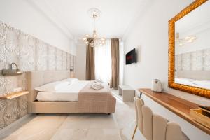 a bedroom with a bed and a mirror at Avenue Suites in Bologna