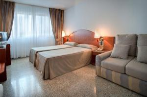 Postel nebo postele na pokoji v ubytování Hotel Gaudi