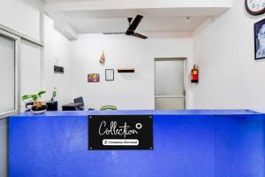 an office with a blue counter with a sign on it at Collection O Bolpur Shantiniketan Railway Junction Ashima Resort in Shānti Niketan