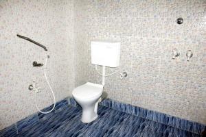 a bathroom with a toilet and a shower at Collection O Bolpur Shantiniketan Railway Junction Ashima Resort in Shānti Niketan