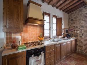 a kitchen with a sink and a stove top oven at Charming Retreat in Armaiolo in Rapolano Terme