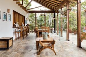 a conservatory with a table and chairs in a room at Villa Romana Boutique Hotel in Canoas de Punta Sal
