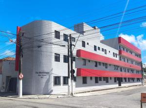 a building on the corner of a street at Flat Residencial dos Anjos in Maceió