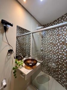 a bathroom with a sink and a shower at Casinhas da Vila in Itacaré