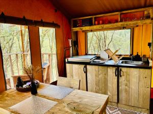 a kitchen with a table and a sink in a room at Lodge A NASSA in Olivese