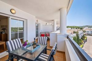 a dining room with a glass table and chairs at Casa del Color - Alcaidesa in San Roque