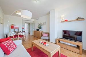 a living room with a couch and a table at Casa del Color - Alcaidesa in San Roque