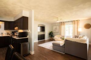 a kitchen and living room with a couch and a table at The Family Haven - 3BD 3BA Home in East Peoria in West Peoria