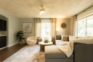 a living room with a couch and a table at The Family Haven - 3BD 3BA Home in East Peoria in West Peoria