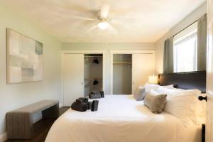 a bedroom with a large white bed with a ceiling fan at The Family Haven - 3BD 3BA Home in East Peoria in West Peoria +88 photos