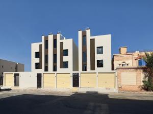 a building with two garage doors in front of it at Roaa Al-Jamwaut in Medina