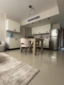 a kitchen with a wooden table and a refrigerator at elegant hotel studio Porto New Cairo pool access in Cairo