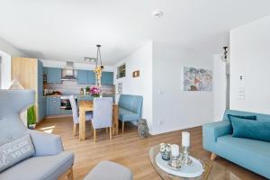 a living room with a blue couch and a table at Pamir in Kappeln