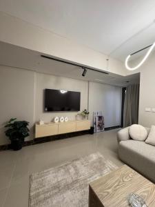 a living room with a couch and a flat screen tv at elegant hotel studio Porto New Cairo pool access in Cairo