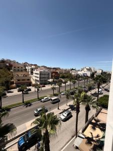 a view of a street with cars and palm trees at Residence Plaza de Toros in Tangier