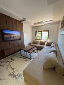 a living room with a couch and a table at Residence Plaza de Toros in Tangier +11 photos