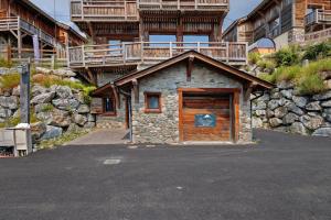 a small building with a wooden door in a parking lot at Chalet Vista - Bolquère in Bolquere Pyrenees 2000