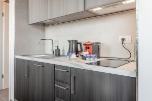a kitchen with a sink and a counter top at FRANTOIO - Suite nel verde con giardino e terrazza privata in Taggia