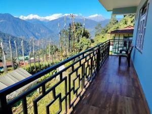 a balcony of a house with a view of mountains at Mochilero Nomads in Pelling