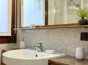 a bathroom with a sink and a mirror at Casa delle Rondini in Vicenza +21 photos